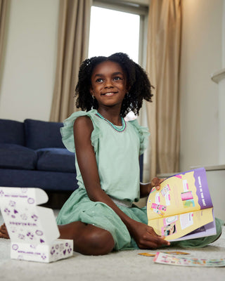 Girl showing her WipalaBox magazine during unboxing