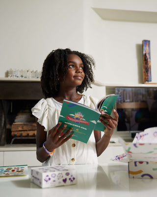 Little girl holding up a Masaai adventure